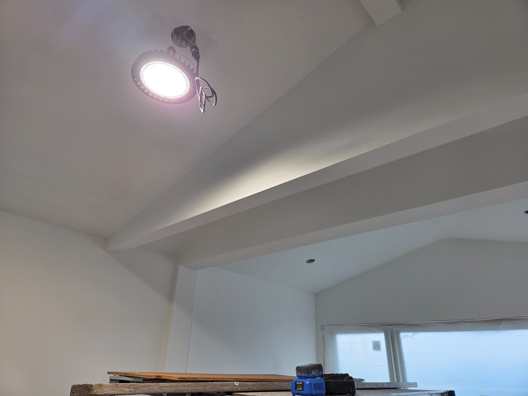Ceiling and beam surfaces during sanding and touch-ups on the Bainbridge Island Class 5 smooth wall project