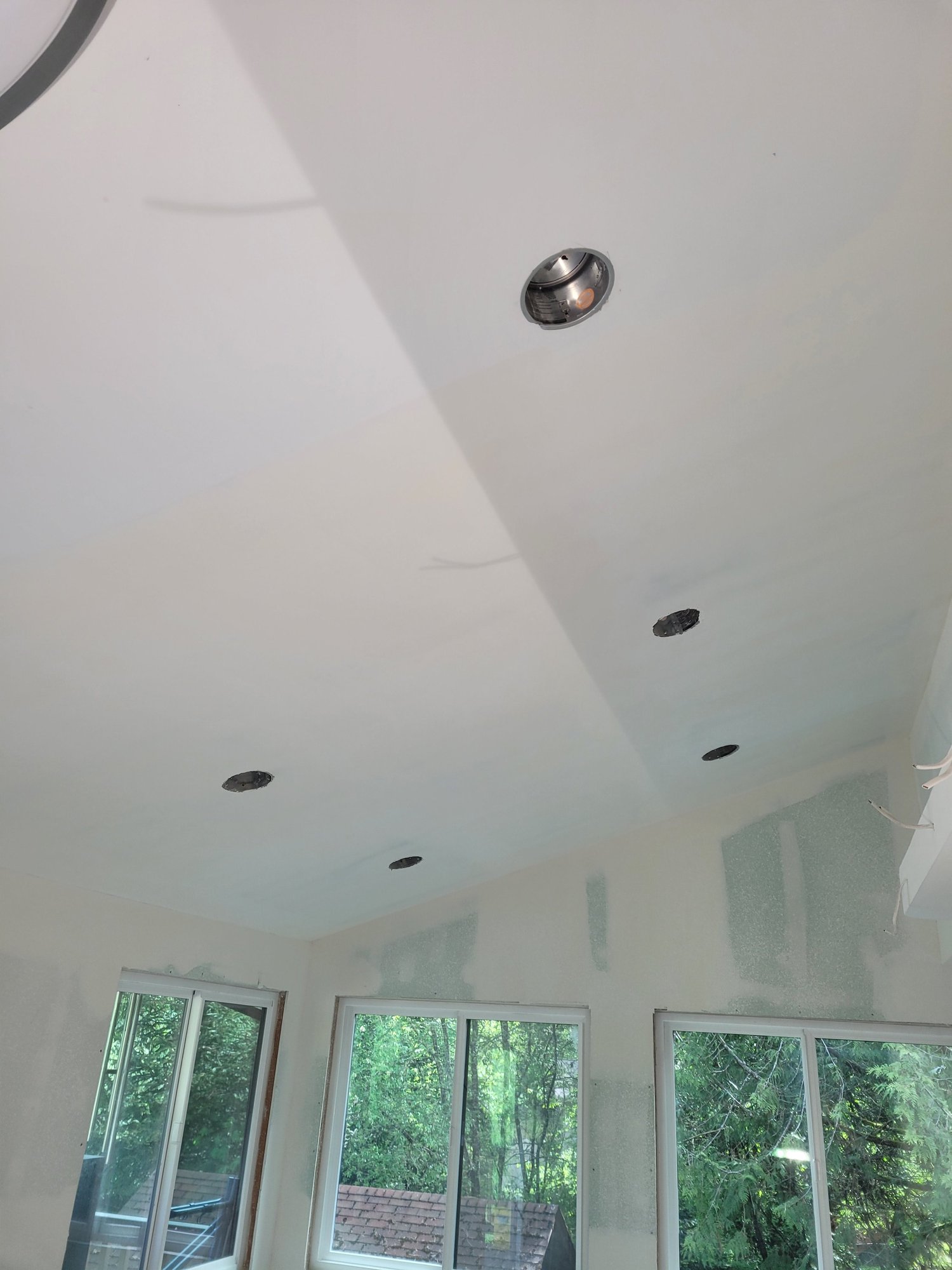 Drywall finishing around recessed lighting and a vaulted ceiling